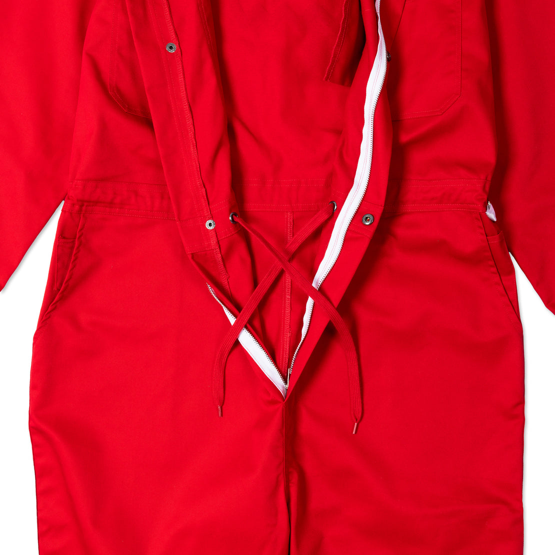 Close-up of a vibrant red Ren jumpsuit showing detailed fabric texture and sleek design.